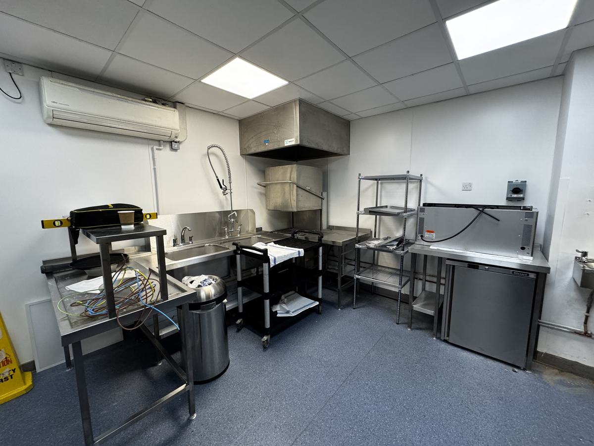 Atrium Kitchen — dishwash area with extraction canopy, Blizzard under-counter refrigeration and stainless shelving