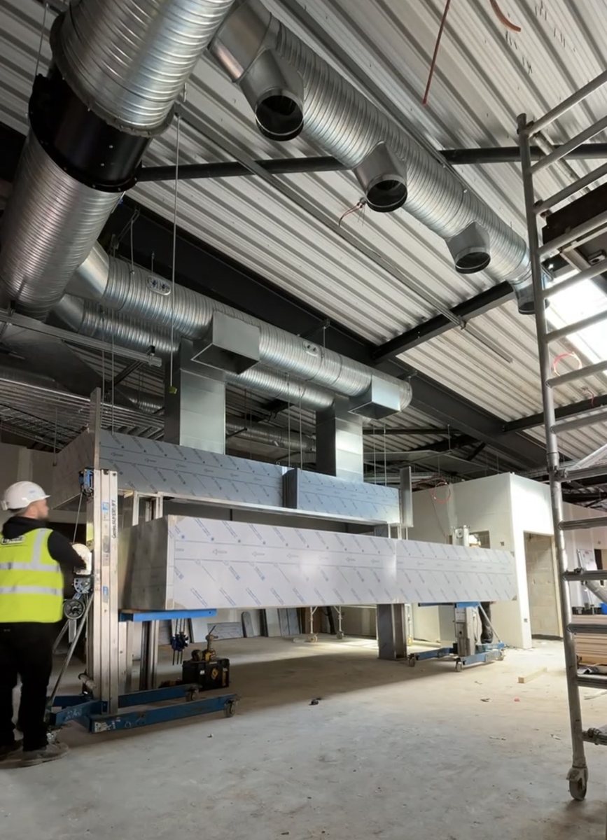 Galvanised spiral ductwork and commercial kitchen extraction run being installed by a Castle Catering Engineers engineer