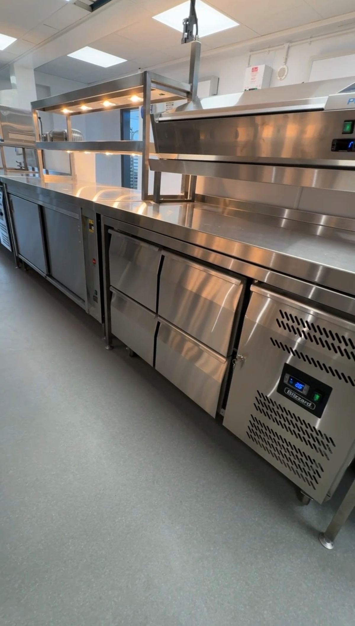 Blizzard refrigerated prep counters and pass shelving — Games Workshop completed kitchen