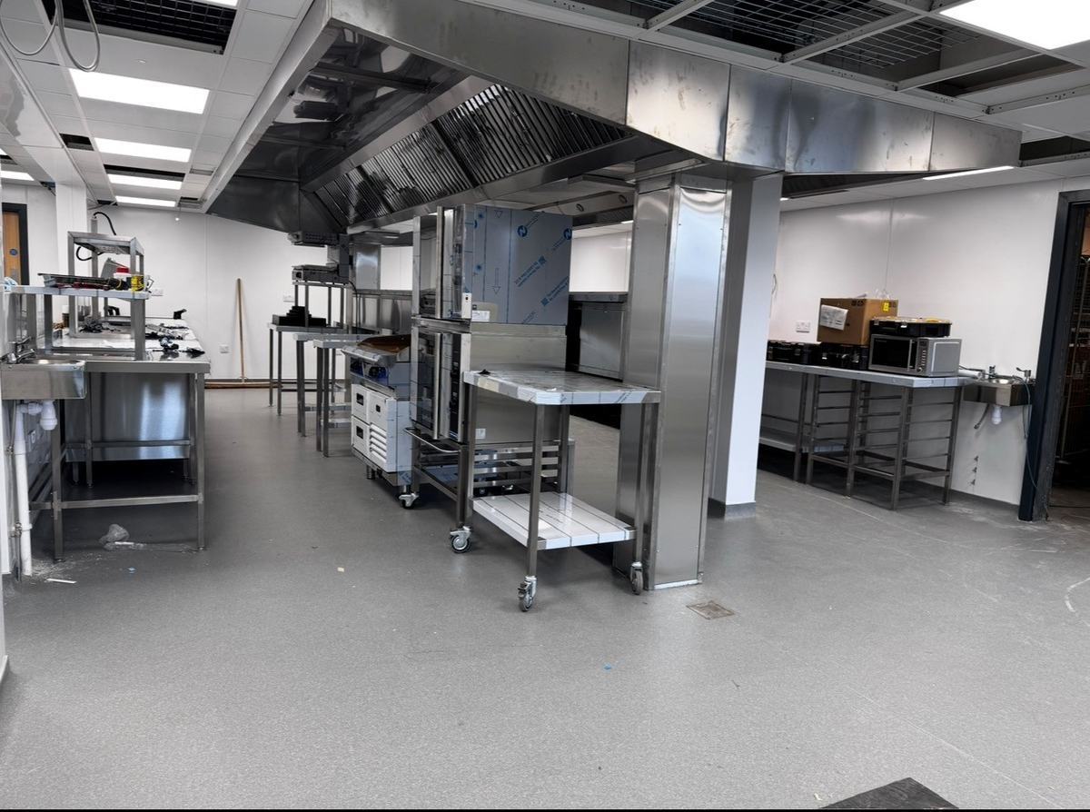 Games Workshop kitchen installation in progress — stainless steel fabrication and extraction canopy fitted