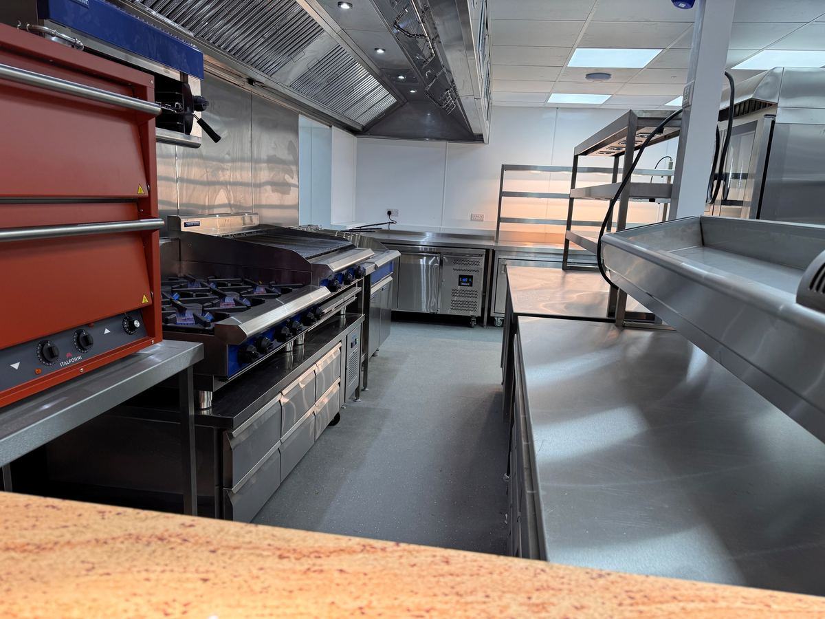Main kitchen — cooking suite with Italforni pizza oven, gas range and CCE extraction canopy