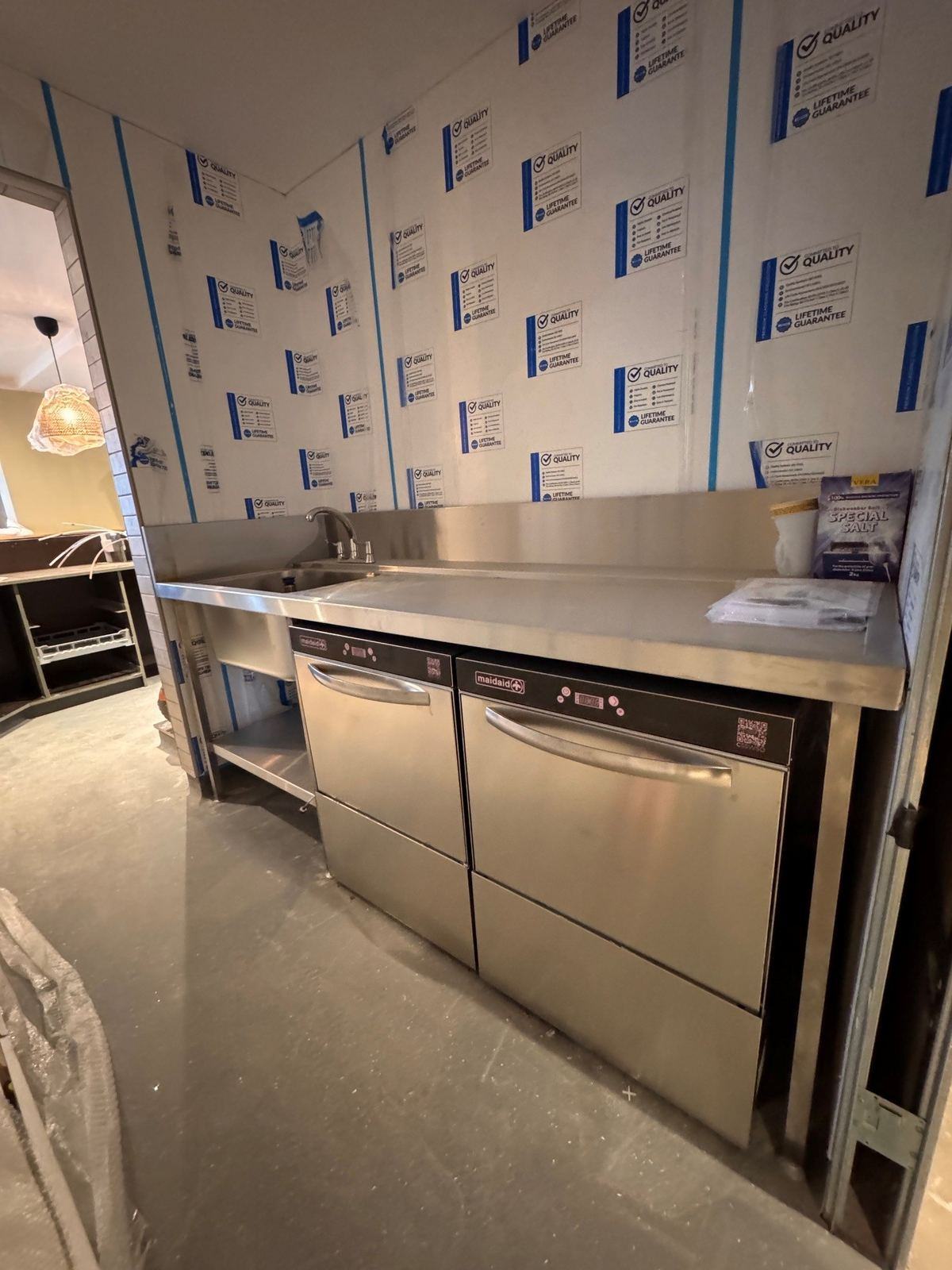 Glasswash room installation — twin Maidaid undercounter glasswashers being fitted