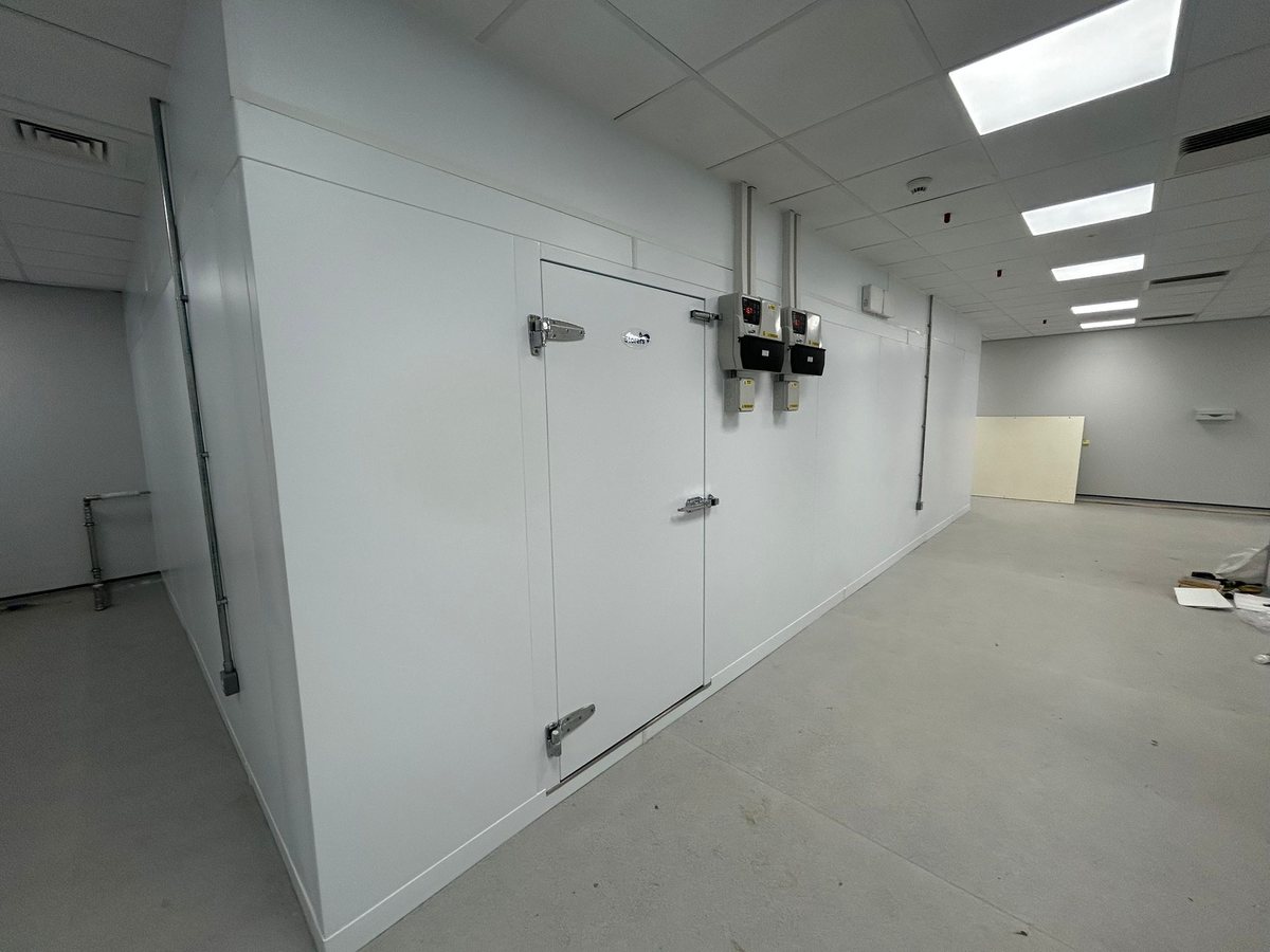Newly installed Storers walk-in cold room and freezer with digital temperature controllers in a commercial kitchen